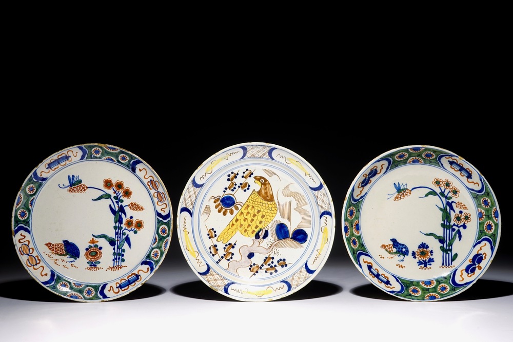 Three polychrome Dutch Delft plates with quails and a parrot, 18th C.