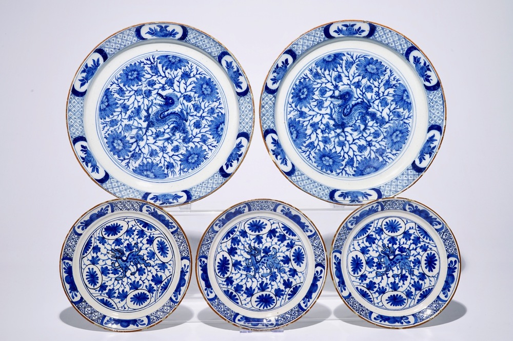 A pair of Dutch Delft blue and white chinoiserie chargers and three matching plates with dragons, 18th C.