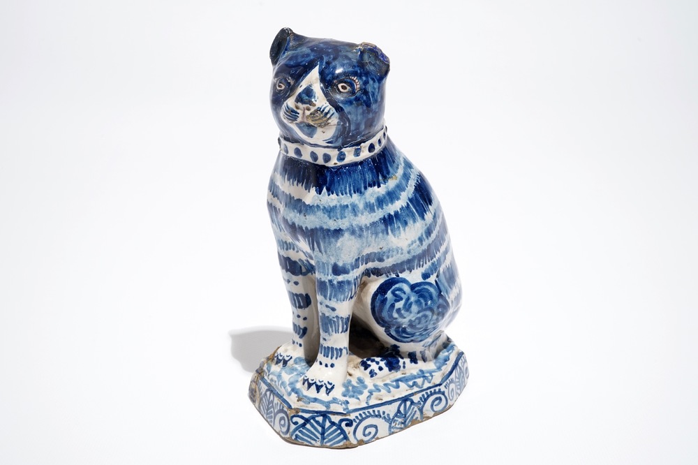 A Dutch Delft blue and white model of a cat, 1st half 19th C.