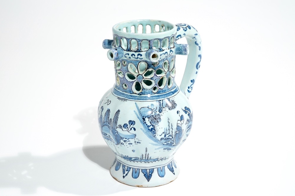 A Dutch Delft blue, white and manganese chinoiserie puzzle jug, dated 1690