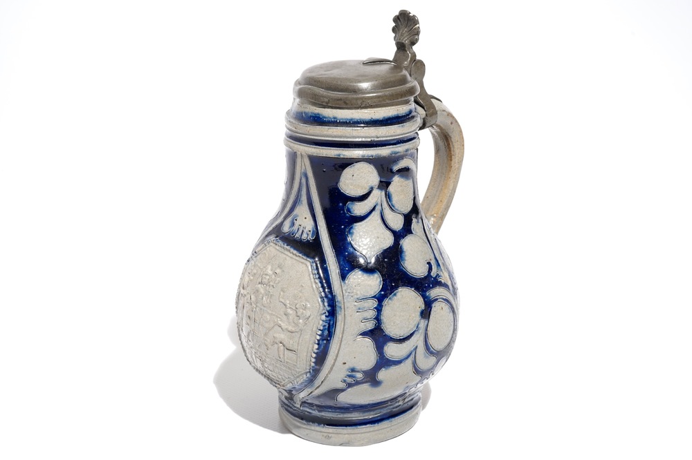 A Westerwald stoneware pewter-mounted jug with a tavern scene, 17th C.