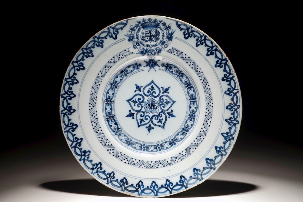 A Dutch Delft blue and white armorial plate, 17th C.