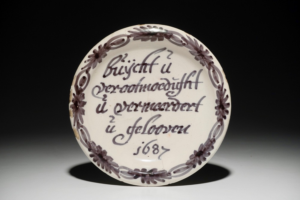 A Dutch Delft blue and white inscribed dish, dated 1687