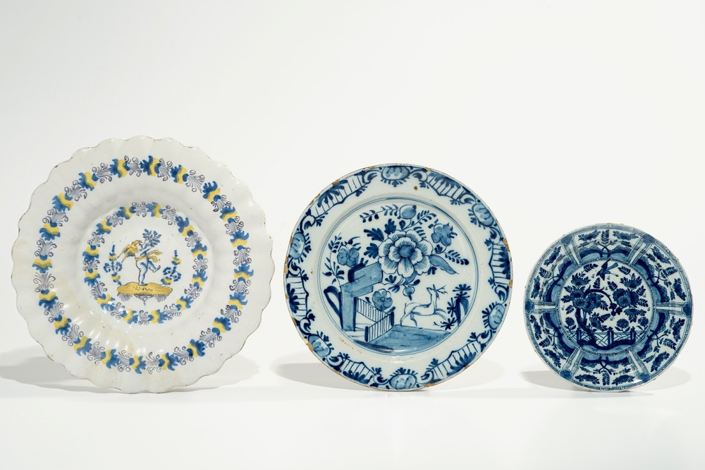 Three various Dutch Delft blue and white plates, incl. a gadrooned dish with a cherub, 17/18th C.