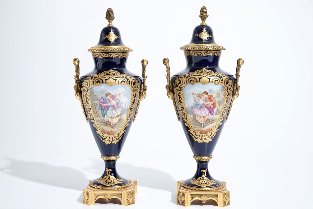 A pair of bronze-mounted Sevres style porcelain vases and covers, 19/20th C.