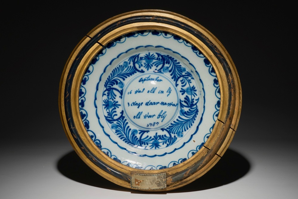 A Dutch Delft blue and white cardinal's dish in frame, dated 1787