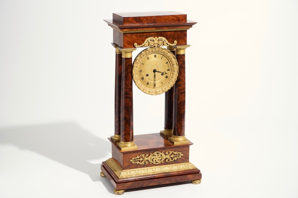 An Empire mahogany and gilt bronze portico mantle clock, France, 19th C.