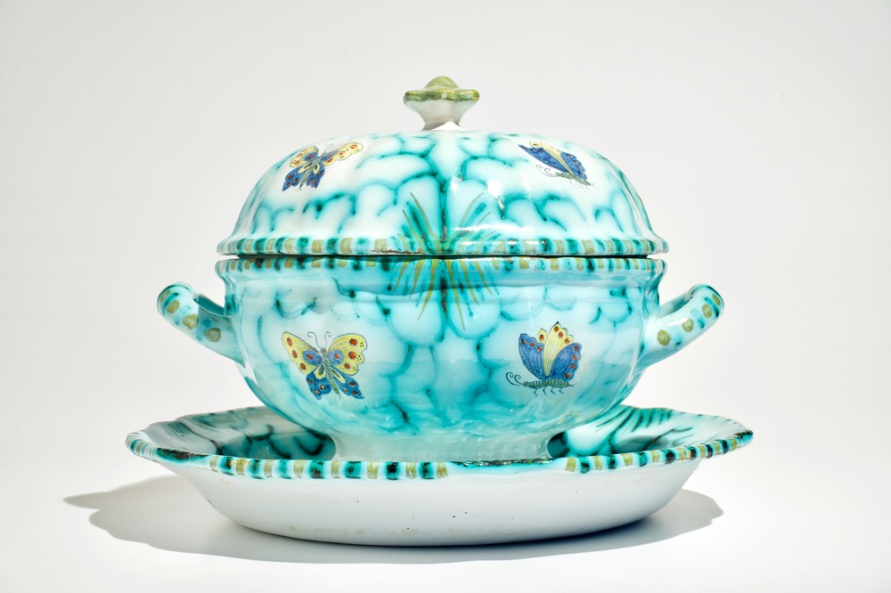 A polychrome Brussels faience tureen on stand with butterflies and caterpillars, 18/19th C.