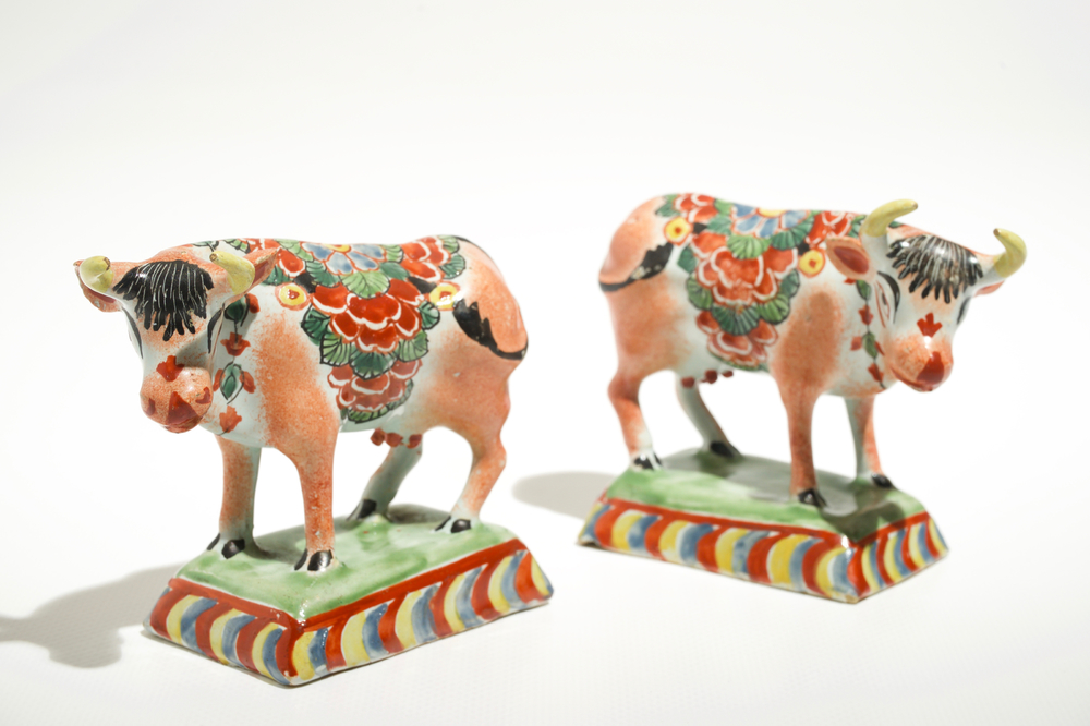 A pair of polychrome Dutch Delft petit feu cows on bases, 18th C.