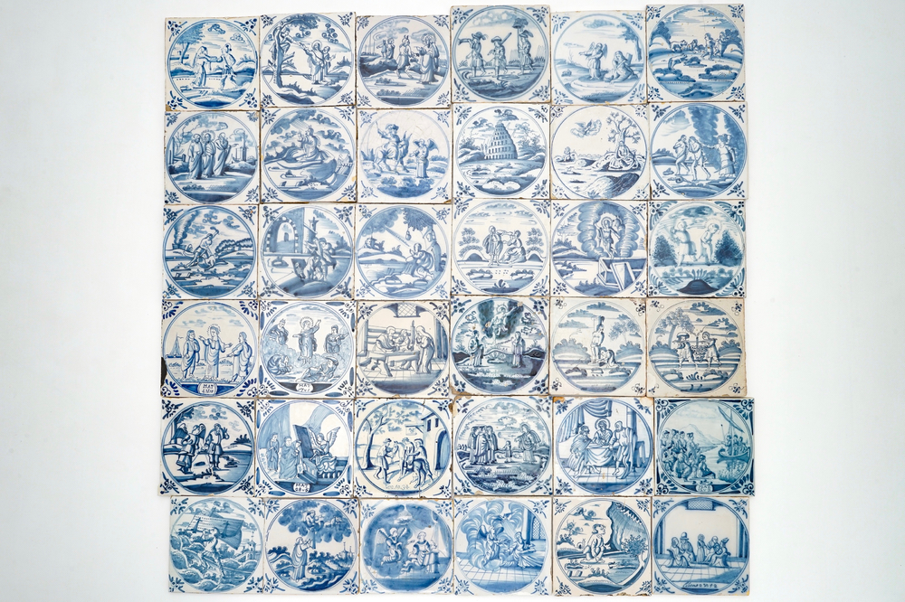 A field of 36 Dutch Delft blue and white tiles with religious scenes in central medallions, 18th C.