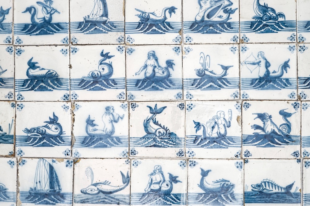A field of 67 Dutch Delft blue and white tiles with sea creatures and ships, 18th C.