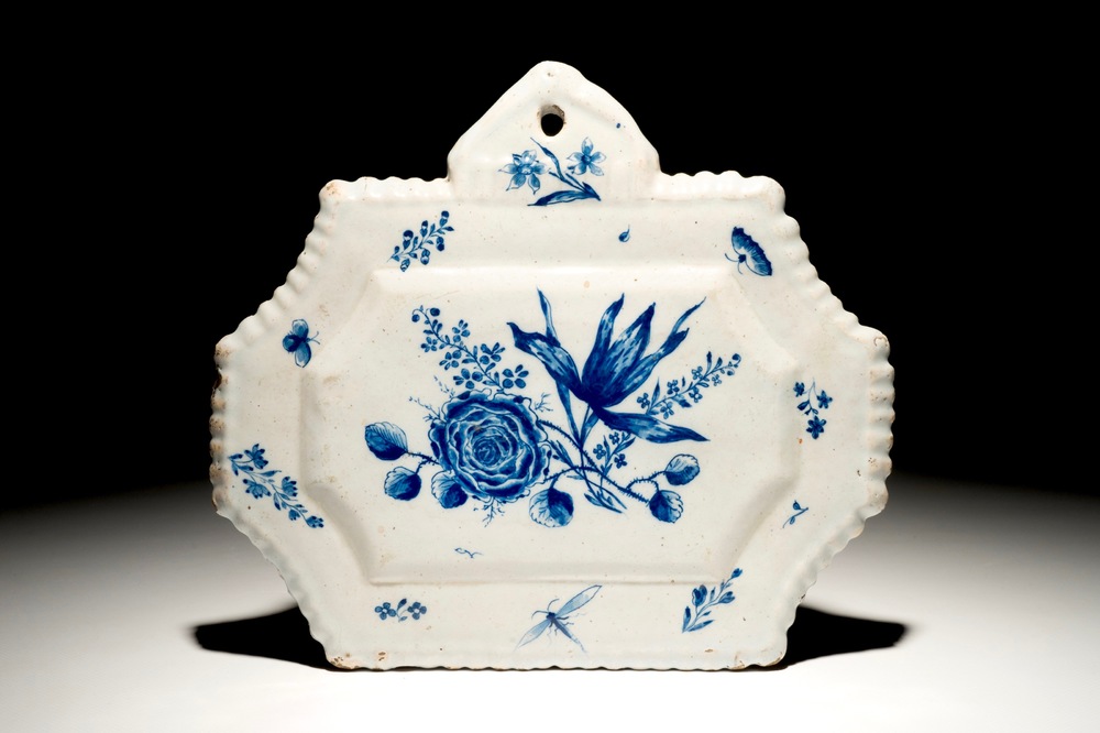 A Dutch Delft blue and white plaque with floral design, 18th C.