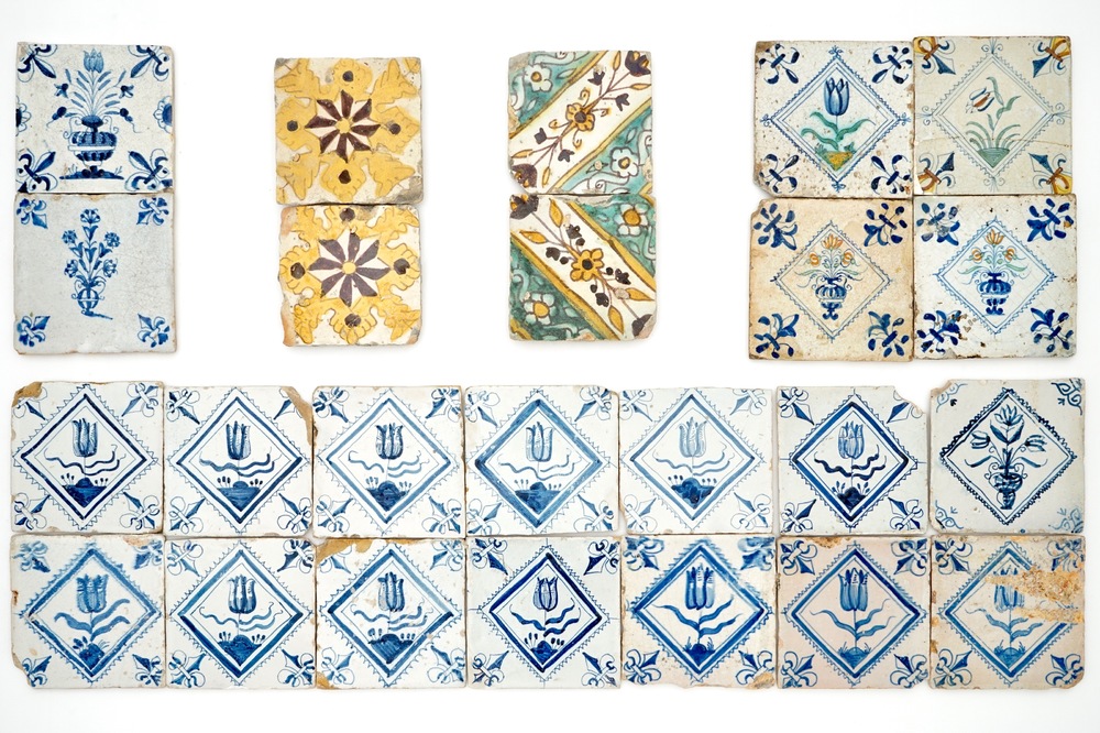 24 polychrome and blue and white Dutch and Spanish Delft tiles with floral designs, 17th C.