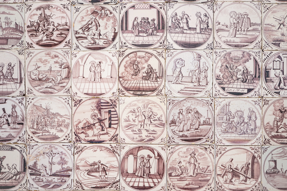 A field of 42 Dutch Delft manganese tiles with religious scenes in central medallions, 18th C.
