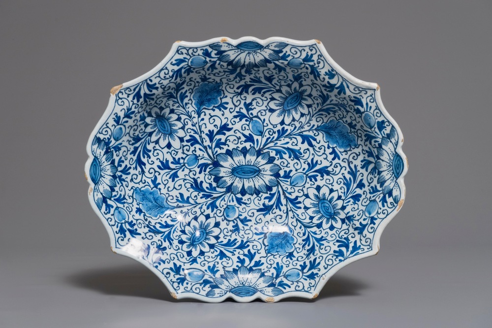 A Dutch Delft blue and white salad bowl with lotus scrolls, 18th C.