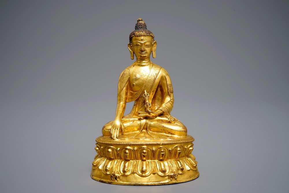 A Tibetan gilt bronze figure of Buddha with vajra, 19th C.