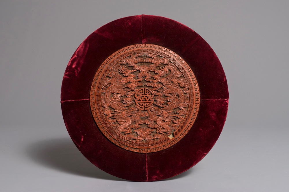 A round Chinese cinnabar lacquer plaque with two dragons, 18th C.
