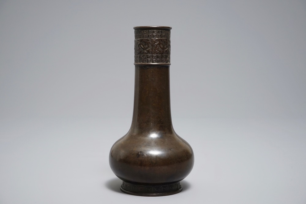 A Chinese bottle-shaped bronze vase with applied design, Yuan