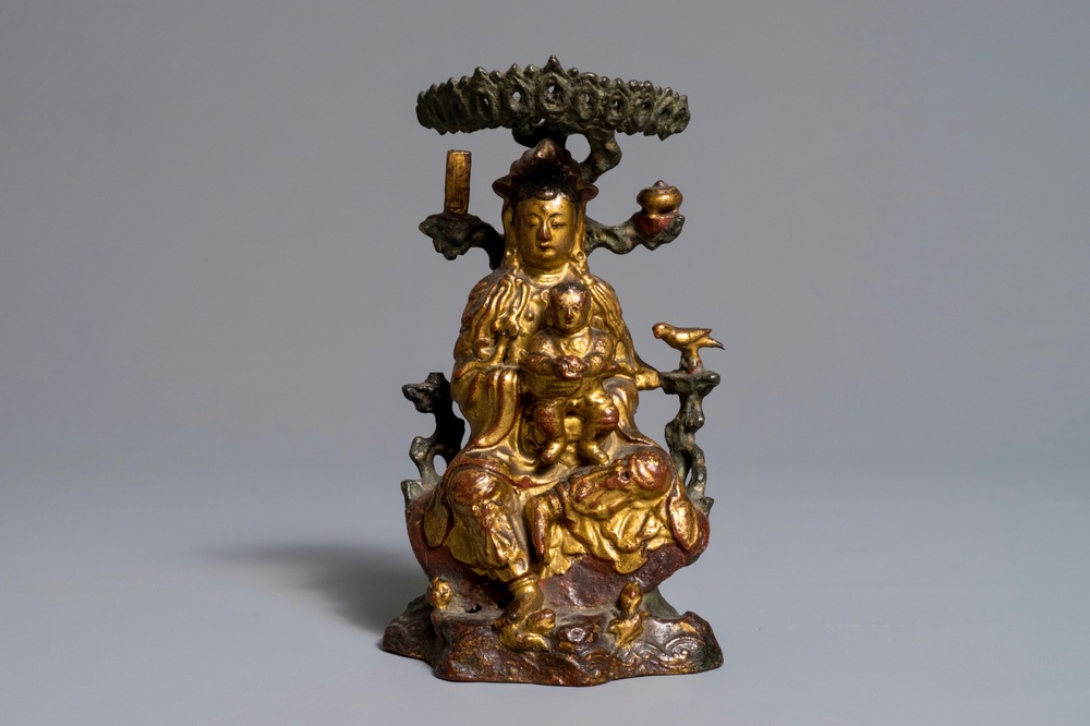 A Chinese gilt-lacquered bronze group of Guanyin with a child, 18th C.