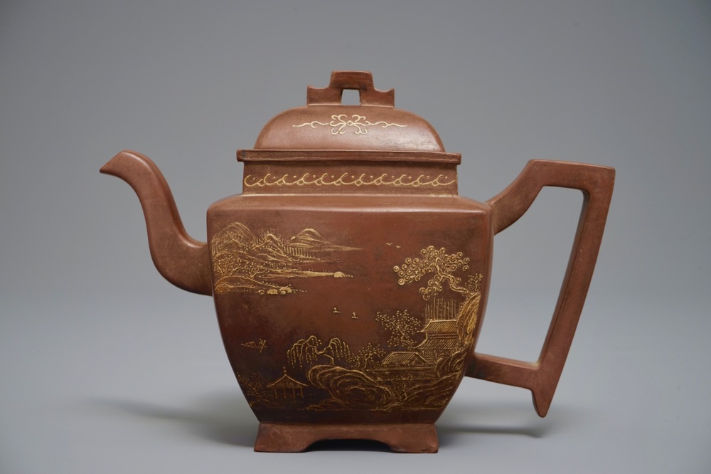 A Chinese Yixing teapot and cover with applied design, 20th C.