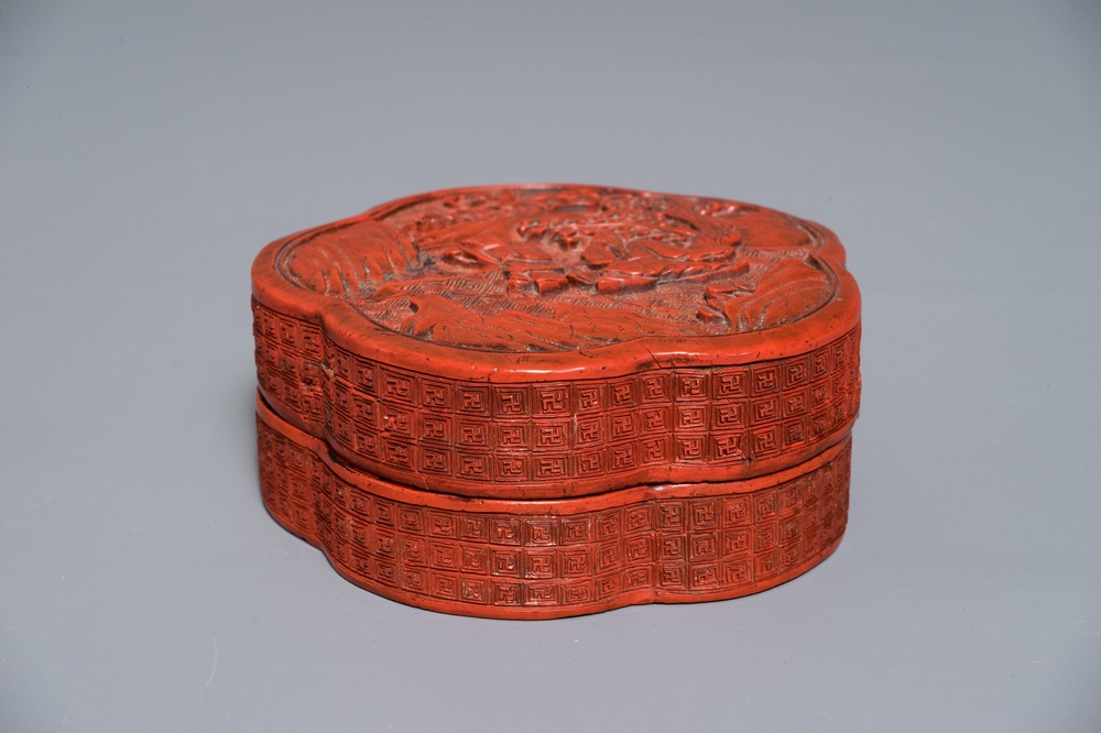 A Chinese flower-shaped cinnabar lacquer box with figures in a landscape, 18/19th C.