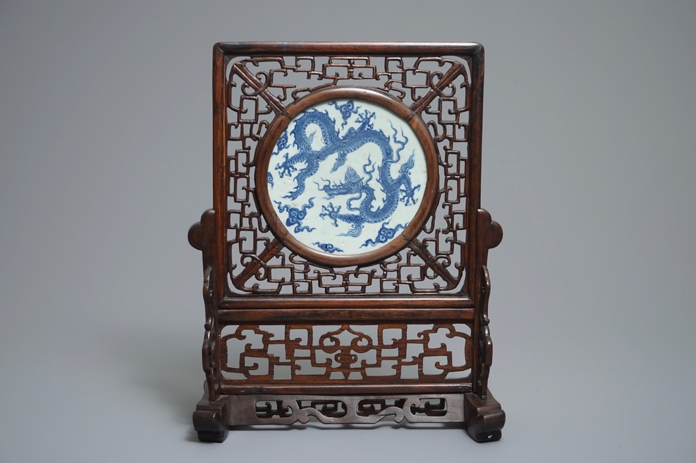 A Chinese carved wood table screen with a blue and white dragon medallion, Ming and 19th C.