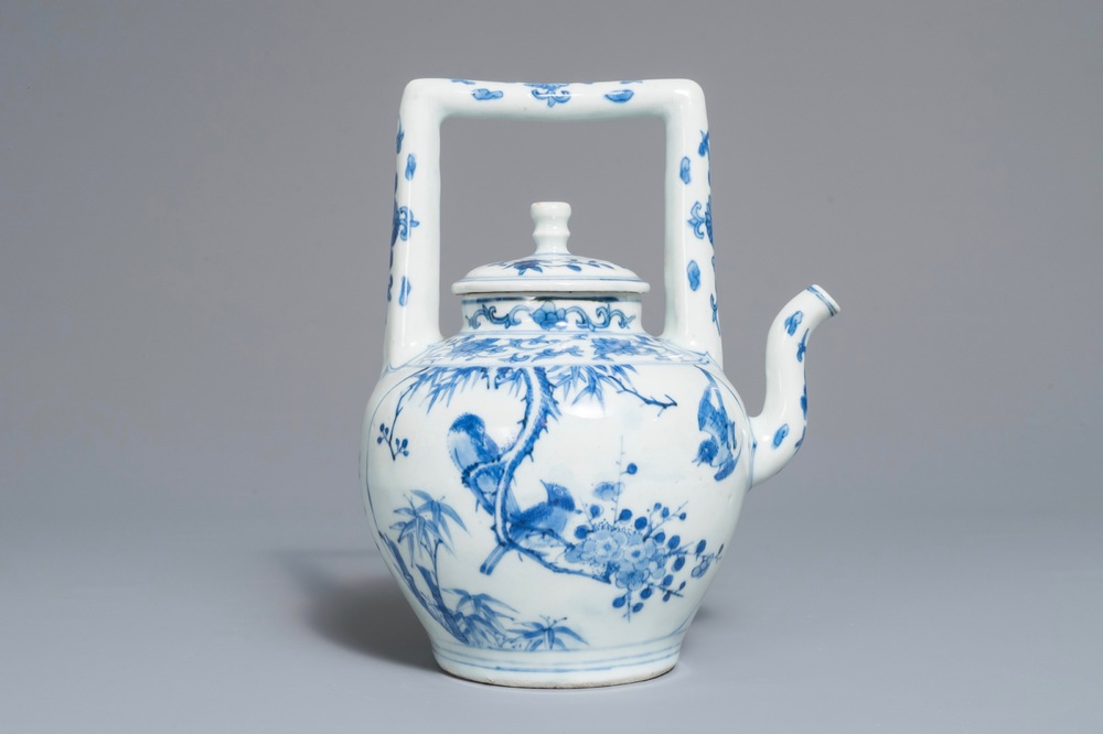 A Chinese blue and white wine jug and cover with fine design of birds and prunus branches, Transitional period