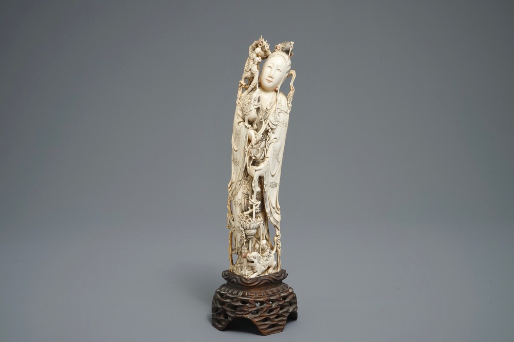 A Chinese carved ivory figure of an immortal with mythical beasts, 19th C.