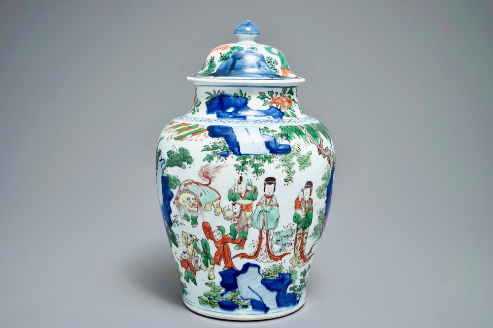 A Chinese wucai baluster vase and cover with figures in a landscape, Transitional period