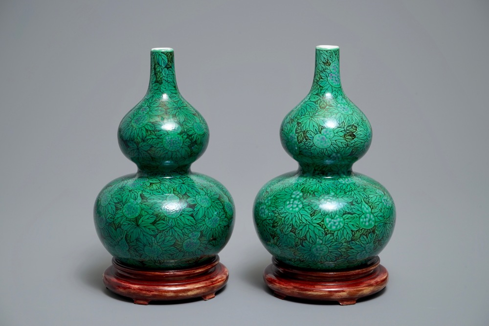 A pair of Chinese double gourd green-ground vases with squash fruit and vines, Republic, 20th C.