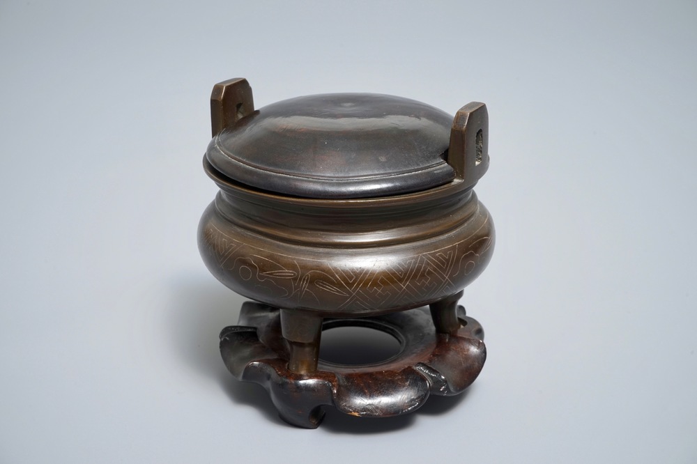 A Chinese silver-inlaid bronze incense burner on stand, 19th C.