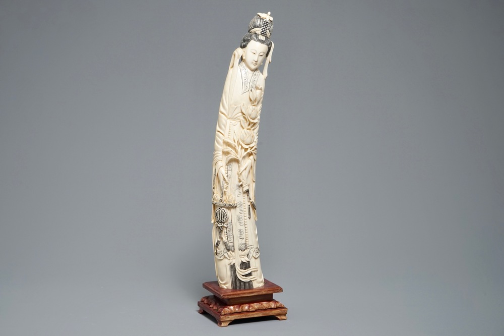 A tall Chinese carved ivory figure of a lady, 2nd half 19th C.