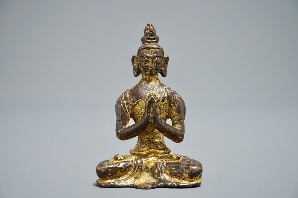 A Nepalese parcel-gilt bronze Buddha Namaskara, 16/17th C.