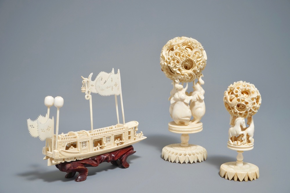 A Chinese carved ivory model of a junk and two Canton puzzle balls, 19/20th C.