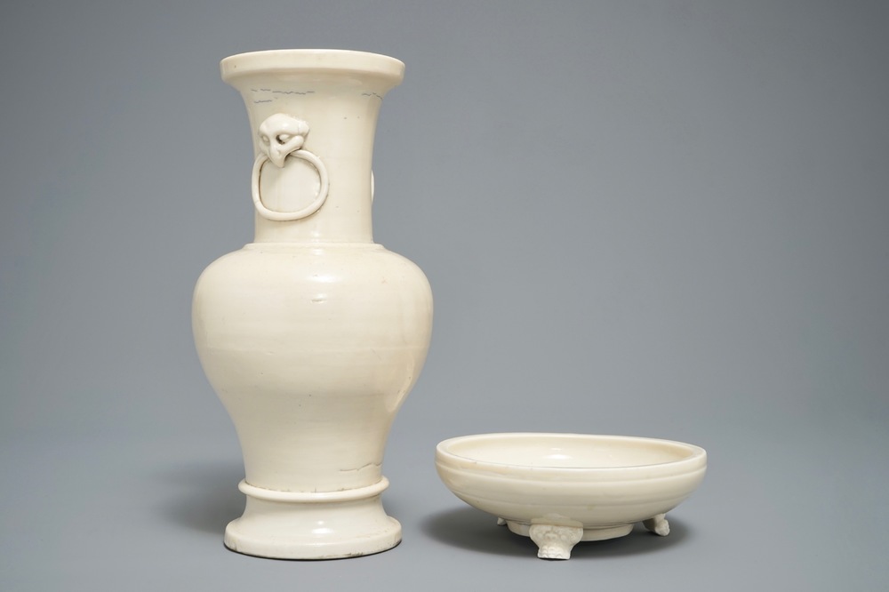 A Chinese monochrome cream-glazed vase and a tripod censer, Ming
