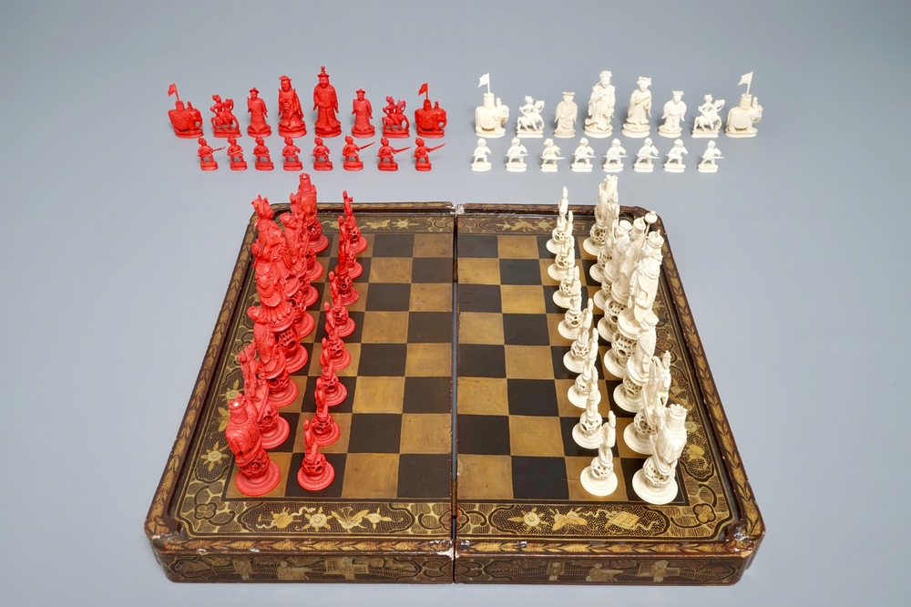 A Chinese lacquered chess and backgammon board with ivory chessmen, 19th C.