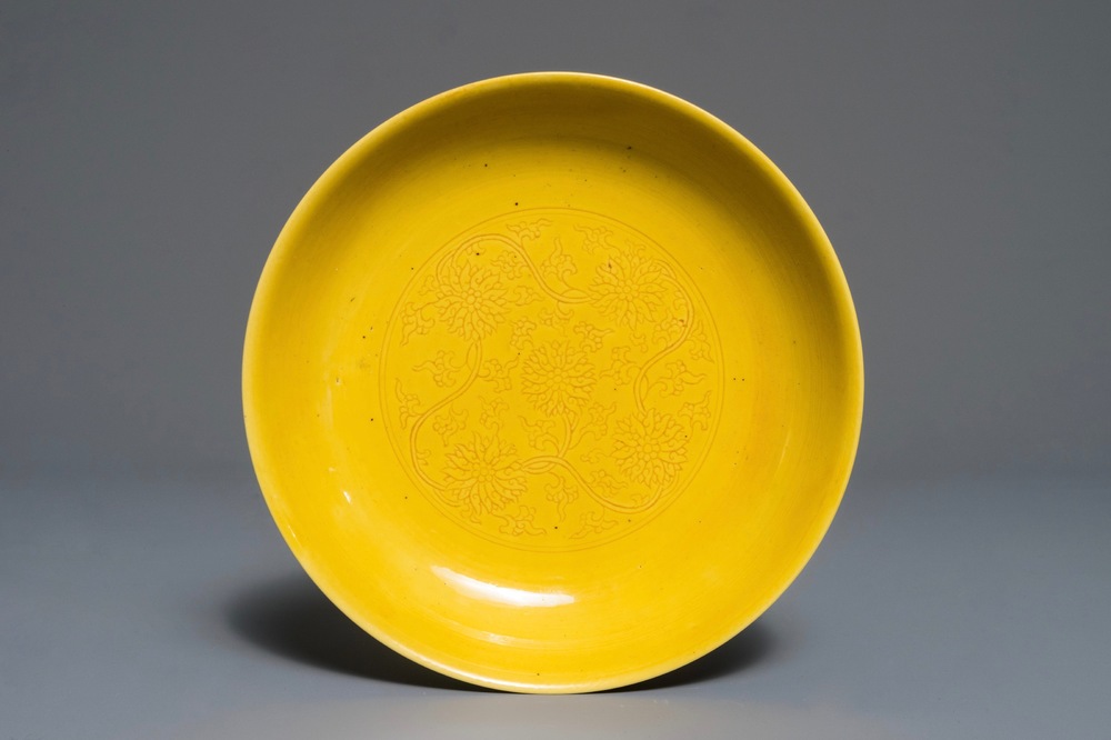 A Chinese monochrome yellow dish with incised lotus design, Kangxi mark, 20th C.