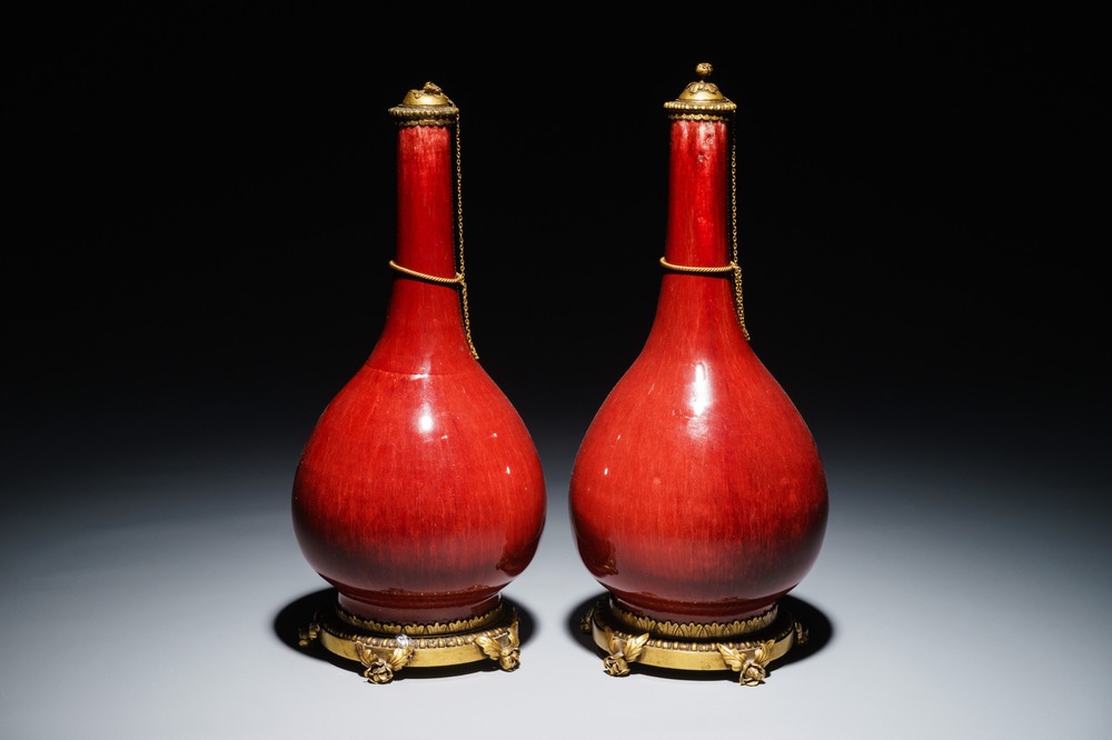 A pair of Chinese gilt bronze-mounted oxblood-glazed vases, 19th C.
