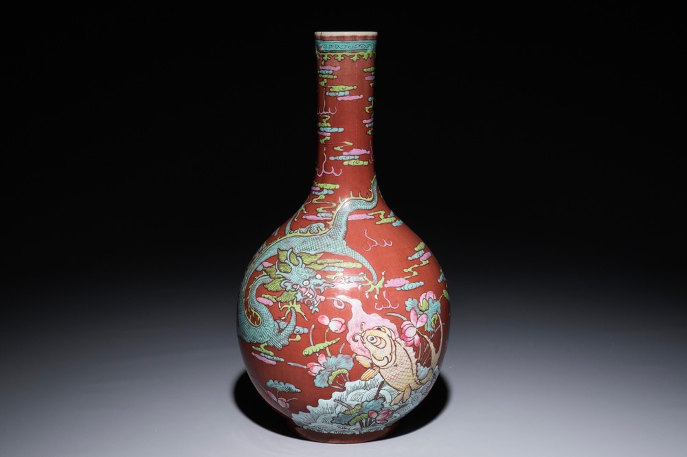 A Chinese oxblood-glazed bottle vase with overglaze design of a dragon and a carp, 19th C.