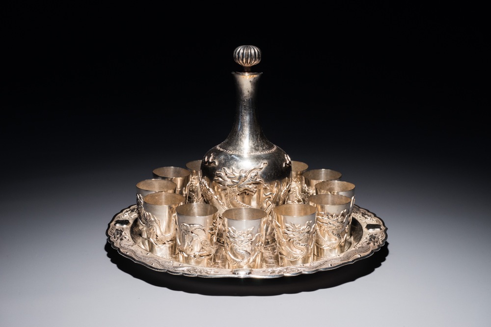 A Chinese silver liquor set on tray with applied dragon design, 19/20th C.