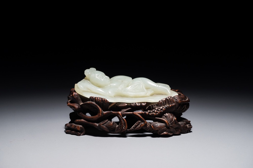 A Chinese celadon jade model of a reclining lady on lotus leaf, Qing