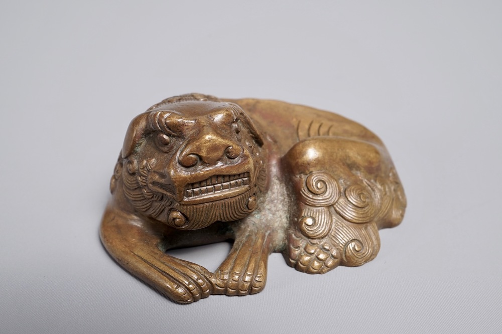 A Chinese bronze scroll or paper weight shaped as a Buddhist lion or Shishi, 17/18th C.