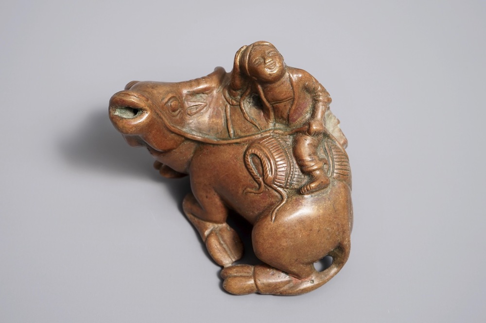 A Chinese bronze water dropper shaped as a boy on a buffalo, 18/19th C.