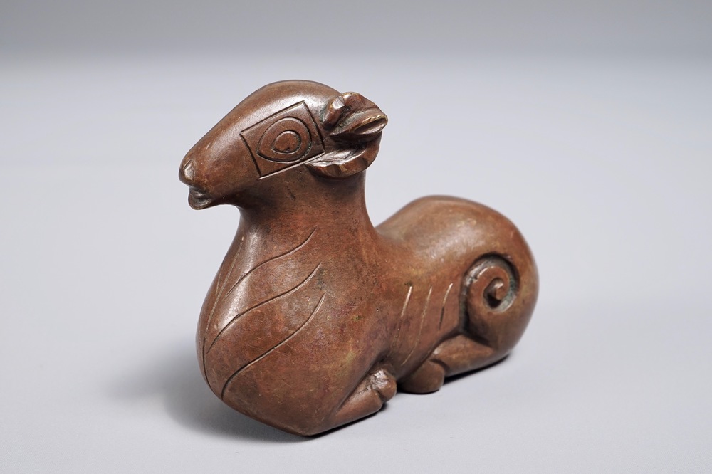 A Chinese bronze scroll or paper weight shaped as a ram, 17/18th C.