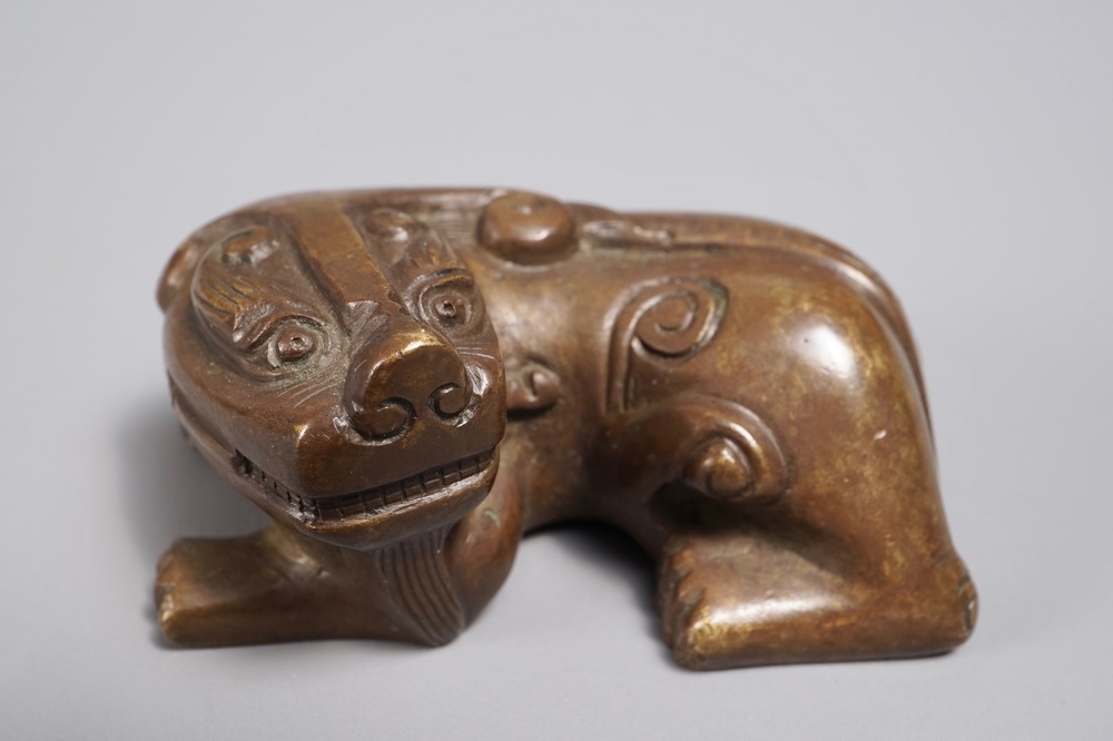 A Chinese bronze scroll or paper weight shaped as a Buddhist lion or Shishi, 18/19th C.