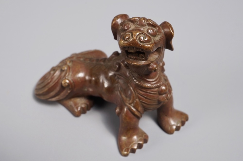 A Chinese bronze scroll or paper weight shaped as a Buddhist lion or Shishi, 18/19th C.