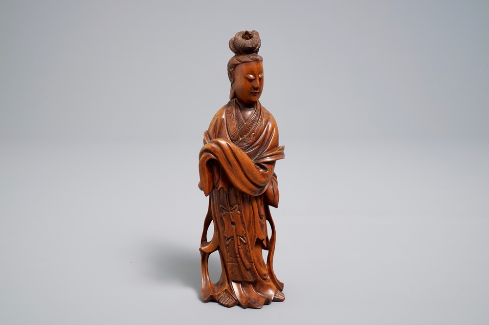 A Chinese carved wood figure of Guanyin standing, 19th C.