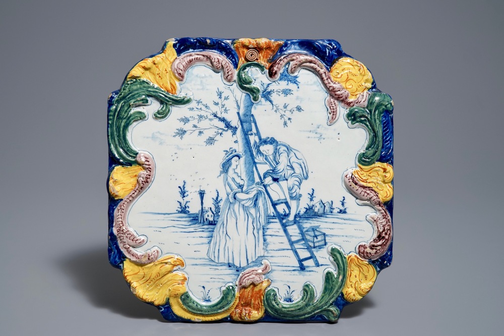 Une plaque en fa&iuml;ence polychrome de Delft &agrave; d&eacute;cor de 'La cueillette de cerises', 18&egrave;me