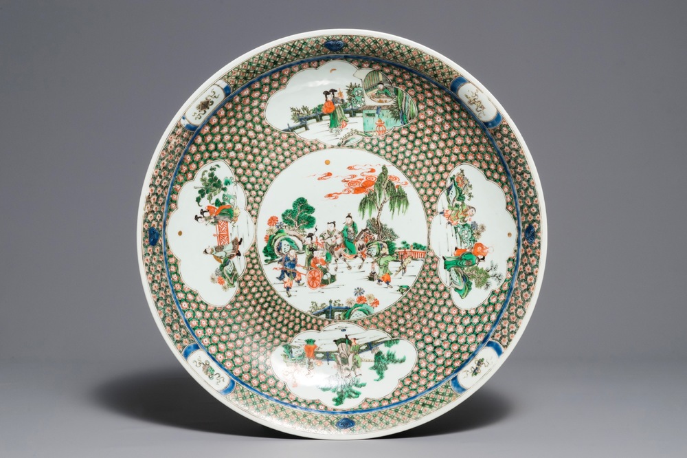 A massive Chinese famille verte dish with figures in a landscape, 19th C.