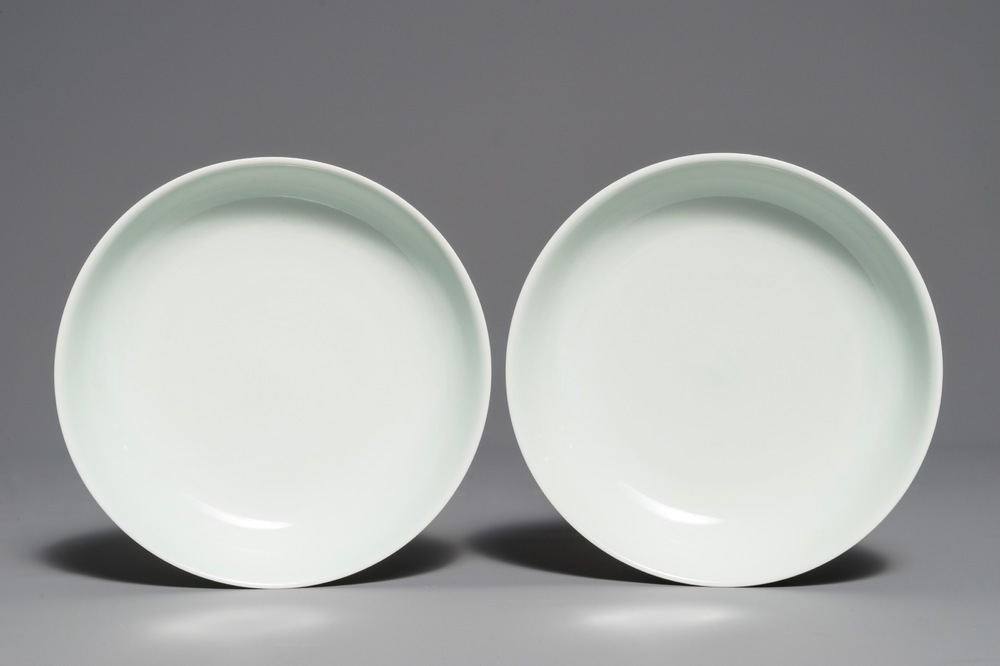 A pair of Chinese pale celadon anhua-decorated plates, Qianlong mark, 19/20th C